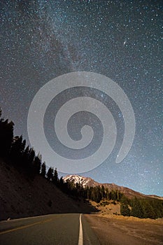 The milky way is shining brightly over the glaciated peak photo