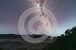 Milky way and stars above Mount Bromo at night. An active volcano and one of the most visited tourist attractions in east Java