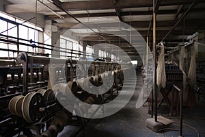 mill, with rows of spinning wheels and weaving looms to produce high-quality fabric