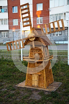 The mill is wooden, the layout of the particle Board is brown, a ray of sun in the blades. Playgrounds,