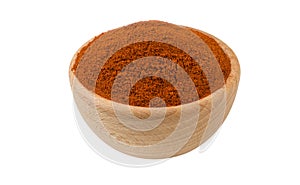 Milled or ground paprika or red pepper in wooden bowl isolated on white background. 45 degree view. Spices and food ingredients