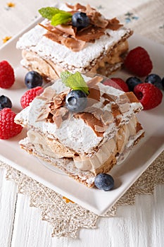 Millefeuille with coffee cream, decorated with berries and mint