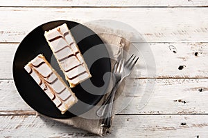 Millefoglie or French mille-feuille on white wooden table.Copy space photo