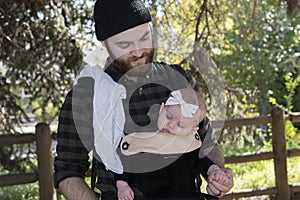 Millenial Dad with Baby in Carrier Outside Walking