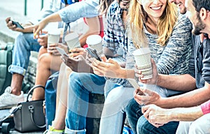 Millenial friends group using smartphone with coffee at university college - People hands addicted by mobile smart phone