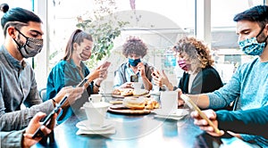 Millenial people using mobile smart phones at coffee bar - New normal lifestyle concept with friends checking contact tracing app