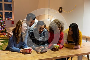 Millennial adult friends celebrating Christmas together at home