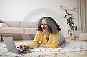 Millennial African American woman using laptop pc, working or studying online, having business meeting or remote lesson