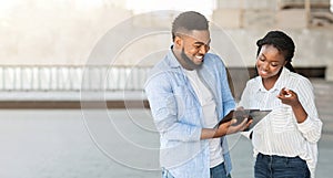 Millennial afro guy answering social survey to female interviewer outdoors