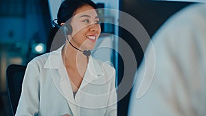 Millennial Asia young call center team or customer support service executive using computer and microphone headset working