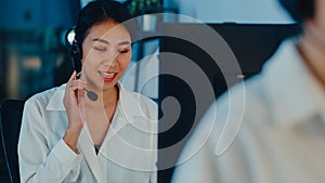 Millennial Asia young call center team or customer support service executive using computer and microphone headset working