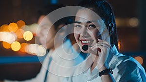 Millennial Asia young call center team or customer support service executive using computer and microphone headset working