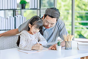 Millennial Asian lovely happy family father helping teaching young little girl daughter using touchscreen tablet computer and