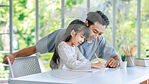 Millennial Asian lovely happy family father helping teaching young little girl daughter using touchscreen tablet computer and