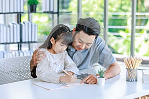 Millennial Asian lovely happy family father helping teaching young little girl daughter using touchscreen tablet computer and