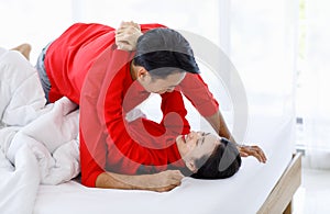 Millennial Asian young romantic lover couple male boyfriend and female girlfriend in red casual outfit laying down smiling