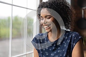 Millennial black woman laugh with closed eyes feel happy