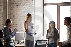 Millennial businesswoman hold meeting with colleagues in office