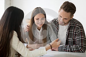 Millennial couple considering mortgage investment loan or insura photo