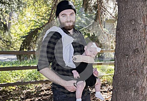 Millennial Dad with Baby in Carrier Outside Walking