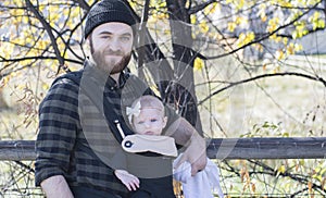 Millennial Dad with Baby in Carrier Outside Walking