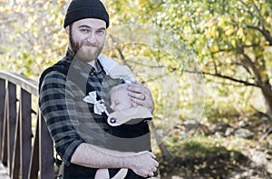 Millennial Dad with Baby in Carrier Outside Walking