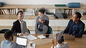 Millennial diverse team having fun at meeting in office.