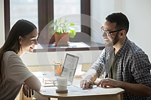 Millennial employees discussing successful business plan in offi