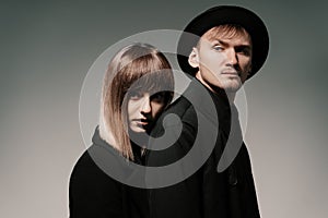 Millennial fashion couple on a gray background in studio