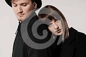 Millennial fashion couple on a white gray background in studio