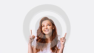 Millennial Girl Pointing Fingers Upward Posing In Studio, Panorama