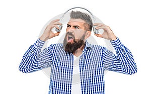 Millennial hipster man listen to music in headphones. Loud music. Man listening audio in loud music headphones. Annoyed