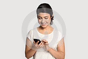 Millennial indian ethnicity woman holding cellular phone.