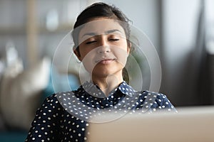 Millennial Indian woman relax at workplace taking nap