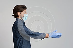 Millennial Man In Medical Mask And Gloves Giving Hand For Handshake