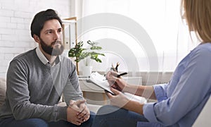 Millennial man talking to specialist at therapy session