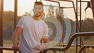 Millennial muscular Strong Arab man with good muscling, pumped up muscles relaxing between exercises during morning