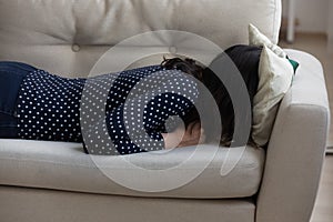 Millennial woman bury head in pillow going through emotional crisis