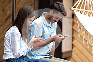 Girl and guy holding smartphones browse internet chatting online photo