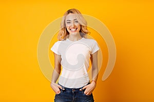 Millennial Woman In White T-Shirt On Yellow Background