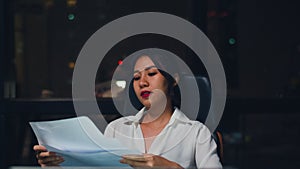 Millennial young Chinese businesswoman working late night stress out with project research problem on laptop in meeting room.