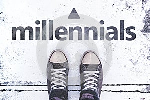 Millennials concept with pair of sneakers on the pavement photo