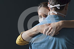Millennials couple wearing a protective face mask and hugging
