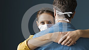 Millennials couple wearing a protective mask and hugging