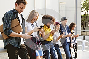 Millennials using smartphones outdoors together photo