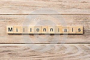 Millennials word written on wood block. millennials text on table, concept