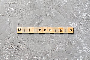 Millennials word written on wood block. millennials text on table, concept