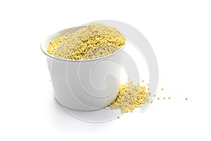 Millet seed in cup isolated on white