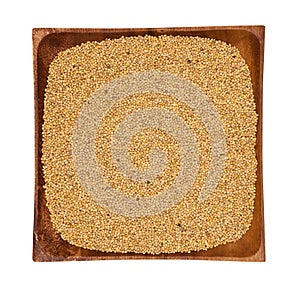 Millet in a wooden bowl on white background