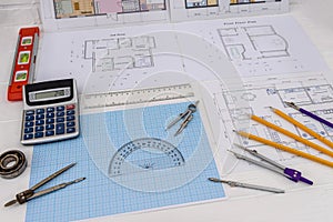 Millimeter paper with drawing tools and house plan